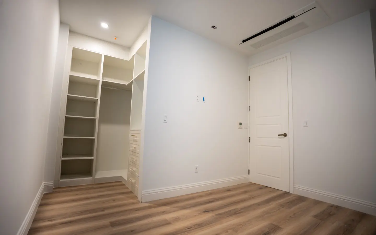 Bedroom with a built-in closet system of open shelving and hanging space at Casa Playa 315
