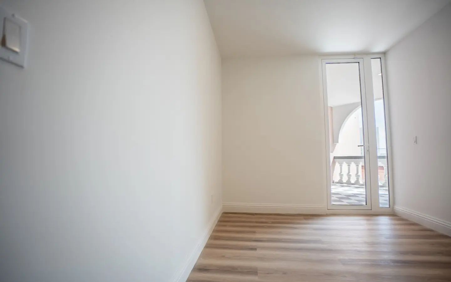 Bedroom with a glass door opening onto the private arched terrace at Casa Playa 315