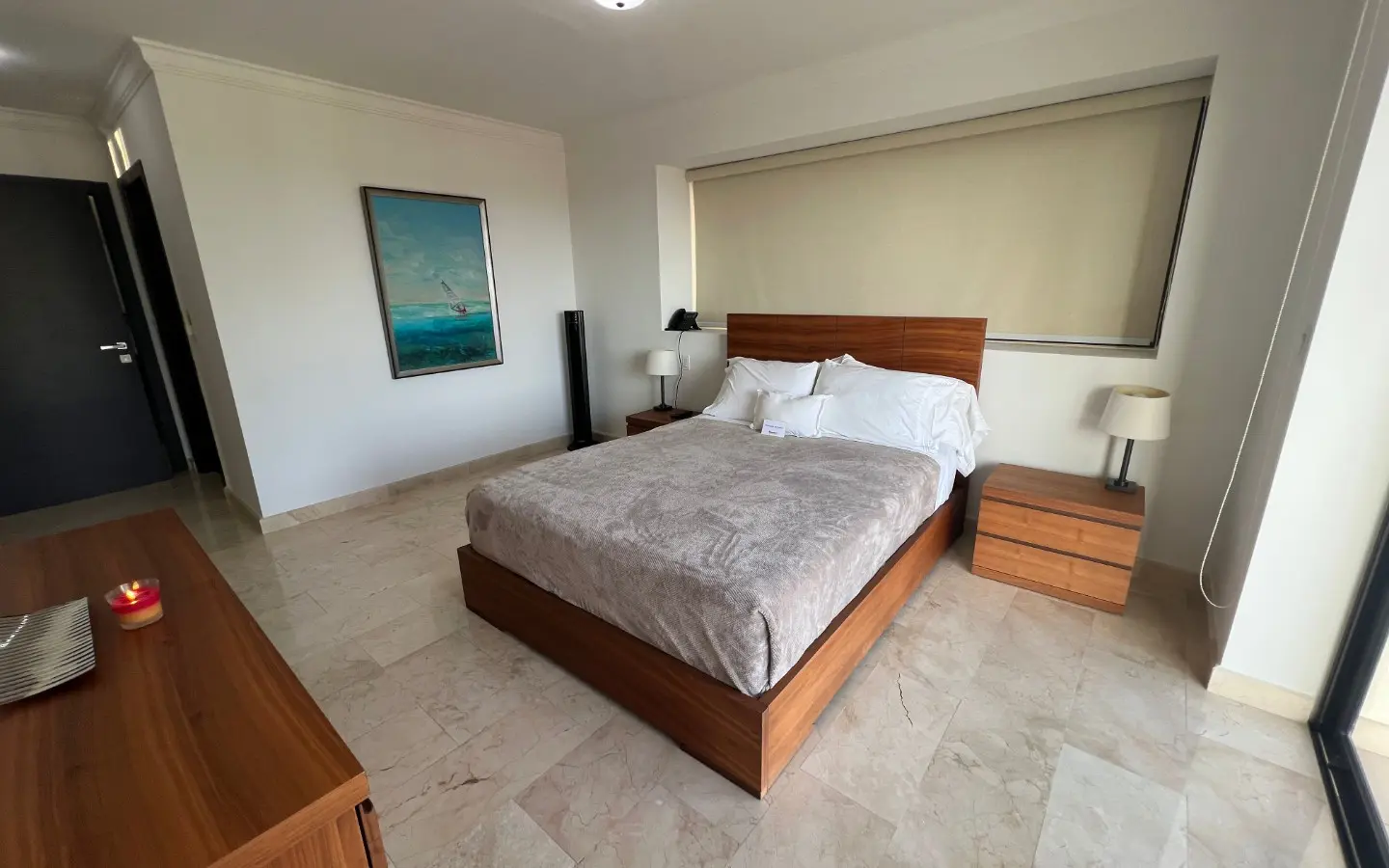 Master bedroom with a king bed and marble floors in PalmAruba Unit 418, Palm Beach, Aruba