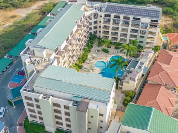 Third bedroom with two twin beds and direct balcony access in the Palm Beach condo