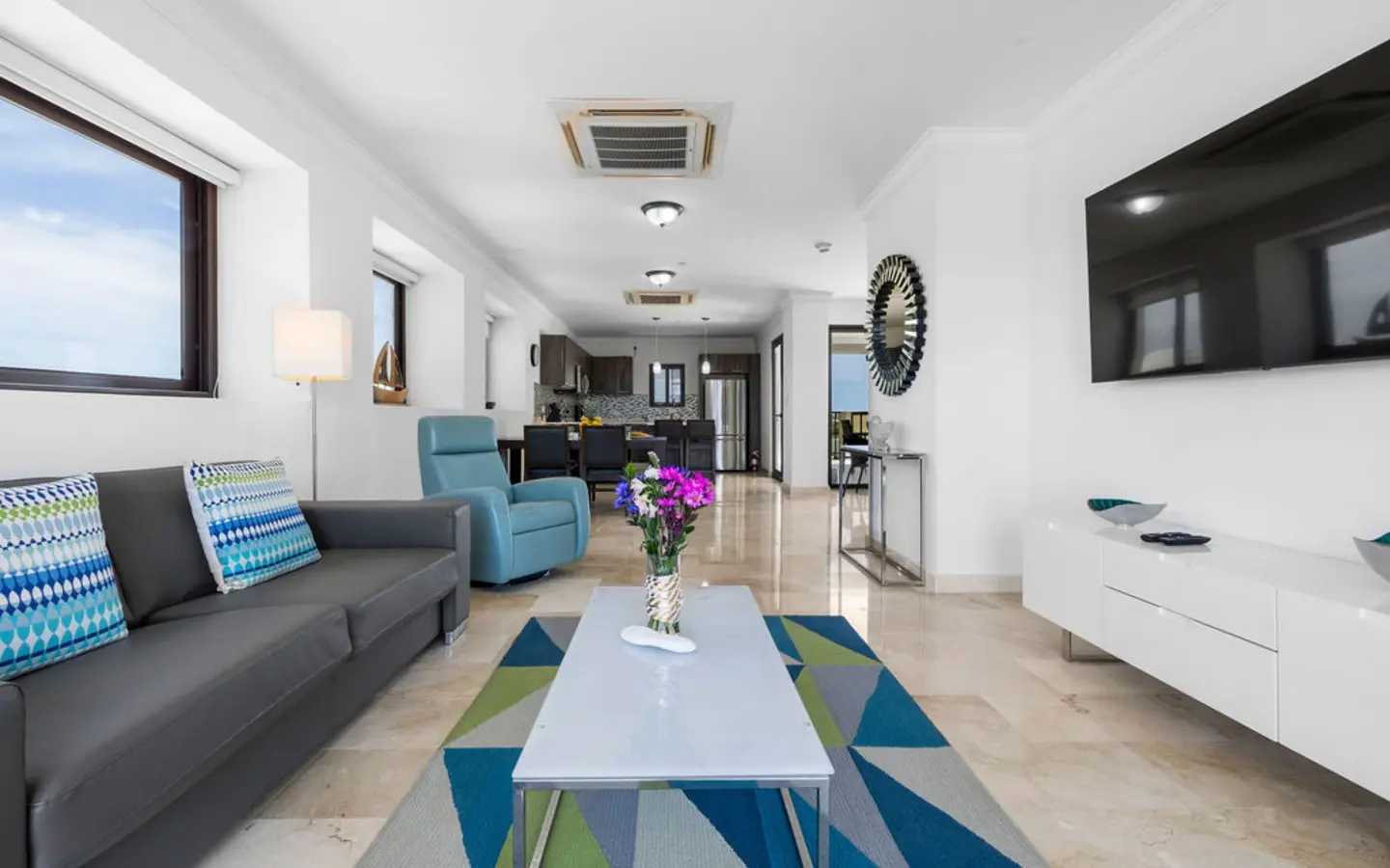 Open-plan living, dining and kitchen in PalmAruba 418, a 3-bedroom condo in Palm Beach, Aruba