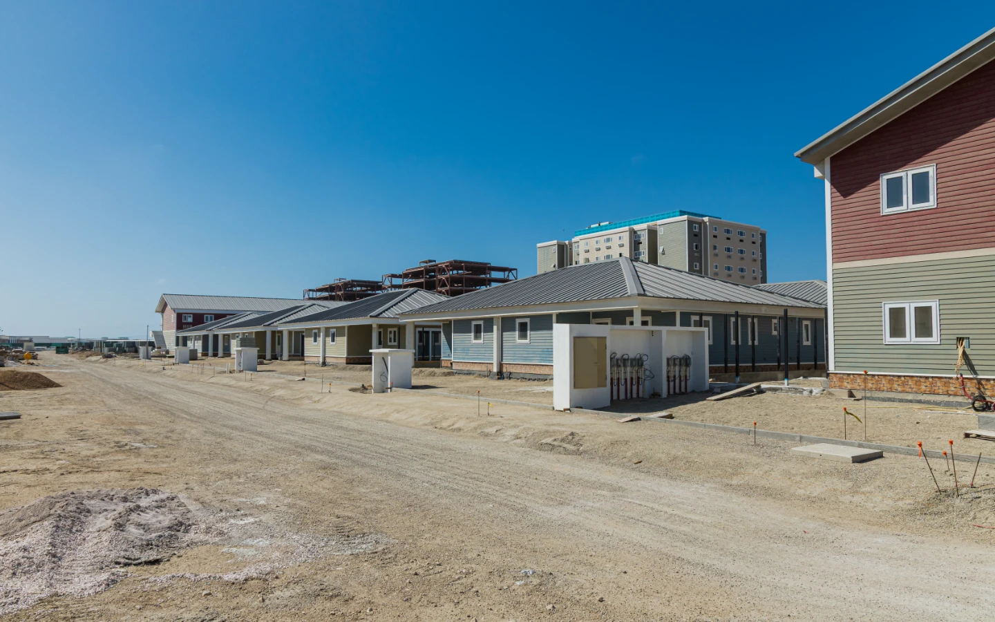 Villa at Caribbean Town seen from the access road, with the plot and paving still being laid