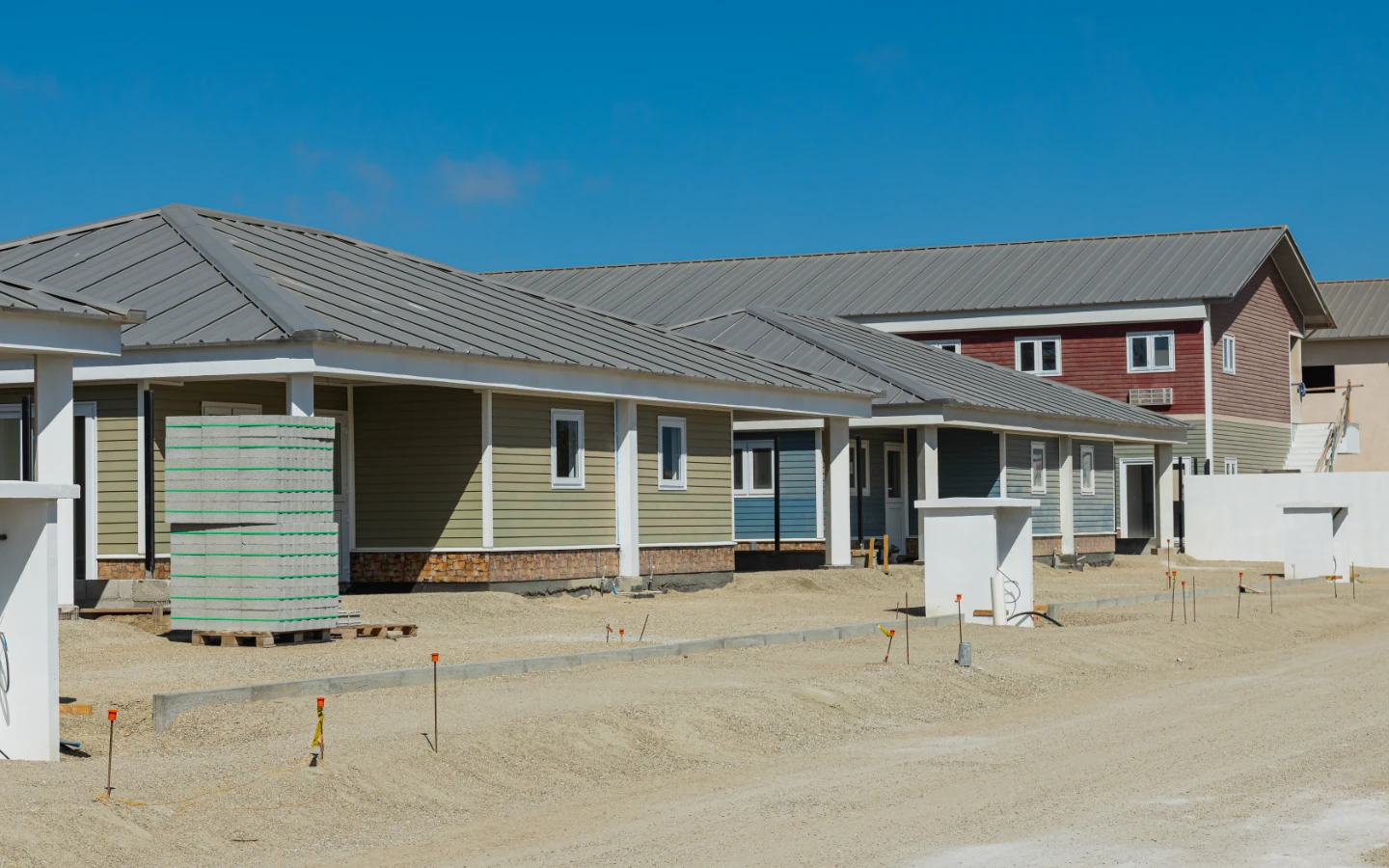 Villa on its plot at Caribbean Town with the surrounding development and towhouses beyond