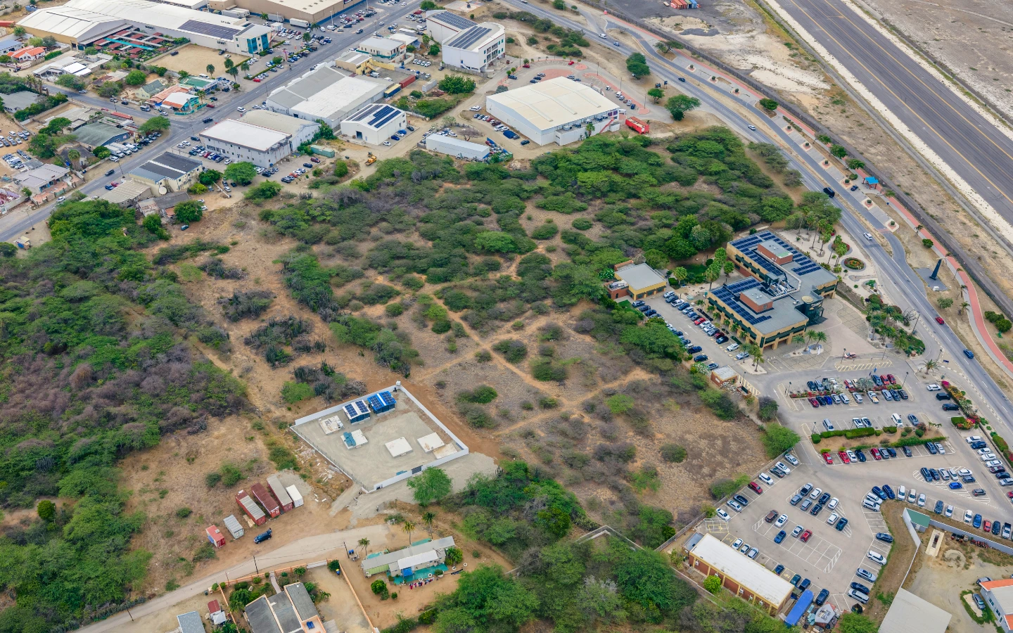 Aerial showing the parcel's road visibility along the illuminated Oranjestad to San Nicolas route
