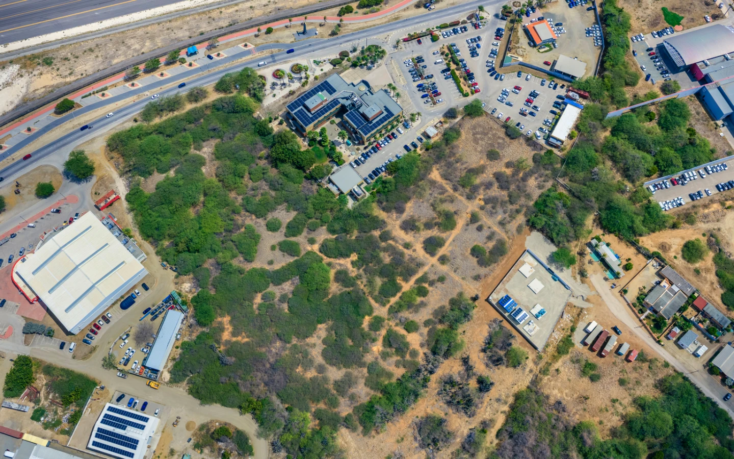 Overhead aerial of the 26,200 m2 Camacuri land parcel beside Aruba Bank on the main road, Aruba